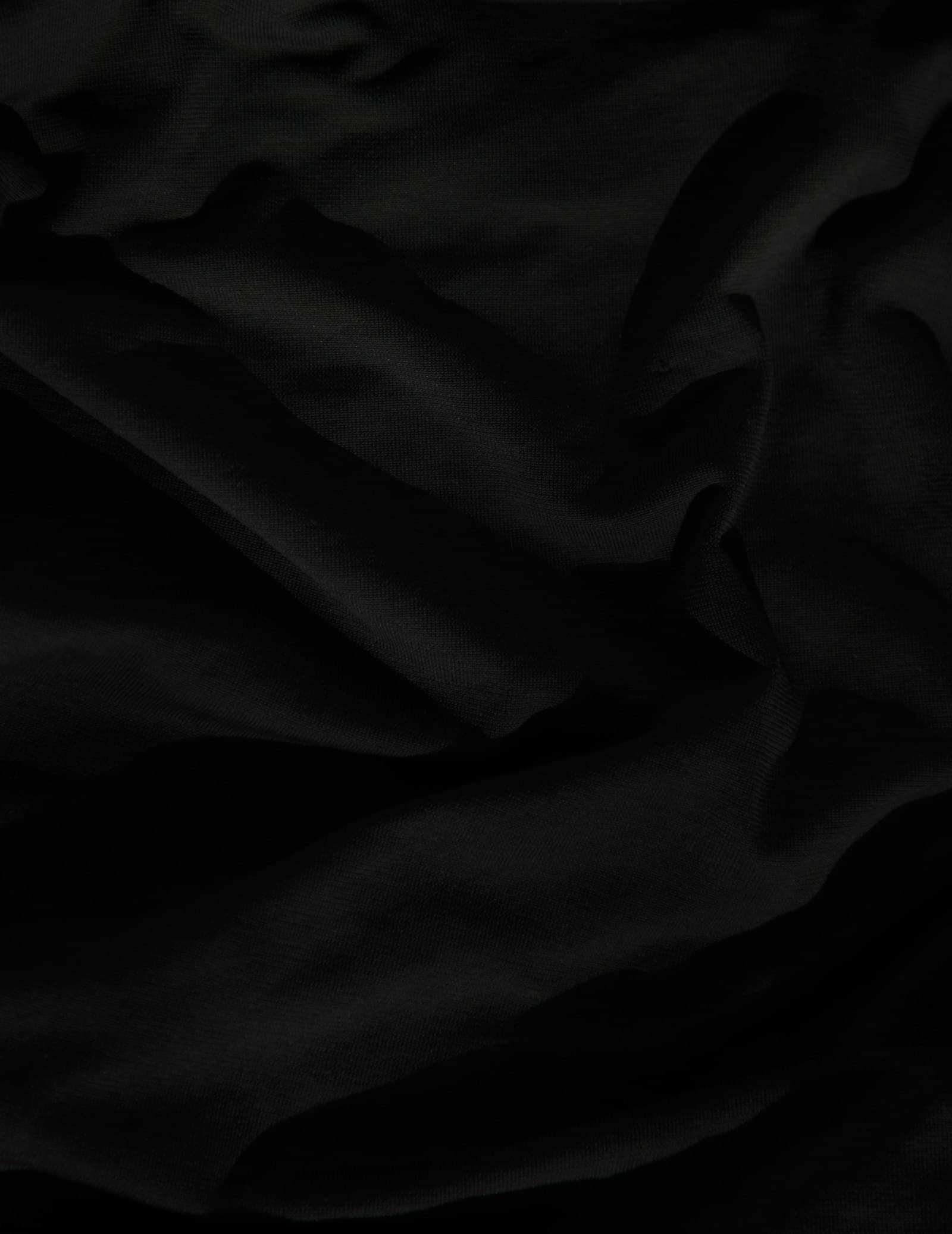 Close-up of draped black linen fabric with soft folds